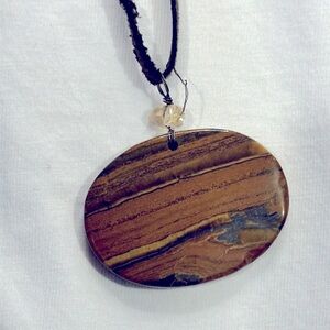 Tiger eye pendant on brown flat cord necklace